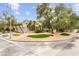 Inviting home with lush landscaping, mature trees, and a circular driveway leading to a two-car garage at 226 Dalmatian Ln, Las Vegas, NV 89107