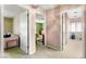Hallway with multiple doorways leading to bedrooms, showcasing a variety of wallpaper and carpet styles at 226 Dalmatian Ln, Las Vegas, NV 89107