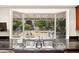 Kitchen sink with backyard view that includes a built-in grill, manicured shrubs, and a covered outdoor area at 226 Dalmatian Ln, Las Vegas, NV 89107