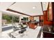 Modern kitchen with dark wood cabinetry, stainless steel appliances, and an island with a cooktop and seating at 226 Dalmatian Ln, Las Vegas, NV 89107