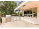 Outdoor kitchen and bar area features a built in BBQ, countertop, and a sink with storage at 226 Dalmatian Ln, Las Vegas, NV 89107