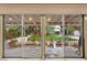 Covered patio with sliding glass doors offering views of the landscaped backyard and manicured lawn at 226 Dalmatian Ln, Las Vegas, NV 89107