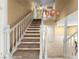 Classic staircase with neutral carpet runner and unique lighting fixture at 226 Dalmatian Ln, Las Vegas, NV 89107