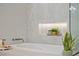 Close-up of a luxurious soaking tub and shower with bright natural light from nearby windows at 2508 Faiss Dr, Las Vegas, NV 89134