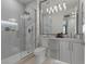 Modern bathroom with a glass shower, marble tile, vanity, and contemporary lighting at 2508 Faiss Dr, Las Vegas, NV 89134