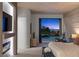 Modern bedroom featuring a decorative wall, fireplace, and sliding glass doors to a private patio and pool at 2508 Faiss Dr, Las Vegas, NV 89134