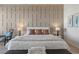 Elegant bedroom featuring stylish wall paneling, a plush bed, and modern furnishings at 2508 Faiss Dr, Las Vegas, NV 89134