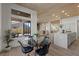 Bright dining area with large windows offering backyard views, complemented by wood floors and modern furnishings at 2508 Faiss Dr, Las Vegas, NV 89134