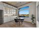 Dining area features pool views, complemented by modern furnishings, light wood floors and trim at 2508 Faiss Dr, Las Vegas, NV 89134