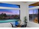 Cozy dining area with views of the pool and city lights through large picturesque windows at 2508 Faiss Dr, Las Vegas, NV 89134
