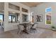 Contemporary dining room with rustic table and decorative brick wall accents at 2508 Faiss Dr, Las Vegas, NV 89134