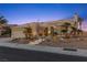 Charming single-story home with well-manicured landscaping, a stone facade, and a three-car garage at 2508 Faiss Dr, Las Vegas, NV 89134
