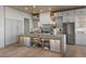 Elegant kitchen featuring custom cabinets, stainless steel appliances, and a large island with open storage at 2508 Faiss Dr, Las Vegas, NV 89134