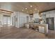 Bright, modern kitchen with stainless steel appliances and a center island is open to the large entry and dining area at 2508 Faiss Dr, Las Vegas, NV 89134