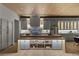 Modern kitchen boasts custom cabinets, stainless steel appliances, and an island with open shelving and built-in lighting at 2508 Faiss Dr, Las Vegas, NV 89134