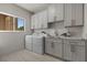 Well-lit laundry room featuring modern washer, dryer, sink, and ample cabinet space at 2508 Faiss Dr, Las Vegas, NV 89134
