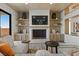 Beautiful living room with fireplace, mounted TV and built-in cabinets at 2508 Faiss Dr, Las Vegas, NV 89134