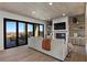 Living room featuring a fireplace, TV, and sliding glass doors to patio at 2508 Faiss Dr, Las Vegas, NV 89134