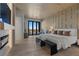 Luxurious main bedroom with fireplace, modern accents, and access to an outdoor space at 2508 Faiss Dr, Las Vegas, NV 89134