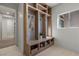 Mudroom with built-in wooden cubbies, bench, and storage baskets near a window at 2508 Faiss Dr, Las Vegas, NV 89134