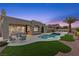 Beautiful backyard pool and patio area with seating, palm tree, and artificial turf at 2508 Faiss Dr, Las Vegas, NV 89134