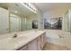 Well-lit bathroom featuring double sinks, a separate shower, and soaking tub at 2925 Wigwam Pkwy # 1124, Henderson, NV 89074