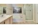 Bathroom with updated fixtures featuring a shower with glass door and soaking tub at 2925 Wigwam Pkwy # 1124, Henderson, NV 89074