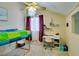 Bright bedroom featuring a colorful bedspread, desk, and ample workspace at 2925 Wigwam Pkwy # 1124, Henderson, NV 89074