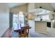 Dining area with bar seating, sliding door access to patio, and an adjacent kitchen at 2925 Wigwam Pkwy # 1124, Henderson, NV 89074