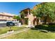 The exterior of the condo shows mature trees, front yard landscaping, and a stairway to the upper level entrance at 2925 Wigwam Pkwy # 1124, Henderson, NV 89074