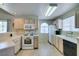 Well-lit kitchen boasts white appliances, light wood cabinetry, and a functional layout at 2925 Wigwam Pkwy # 1124, Henderson, NV 89074