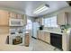 Charming kitchen features light wood cabinets, white appliances, and a bright, airy atmosphere at 2925 Wigwam Pkwy # 1124, Henderson, NV 89074