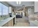 Kitchen area featuring a breakfast bar overlooking the living room, and light-colored cabinetry at 2925 Wigwam Pkwy # 1124, Henderson, NV 89074