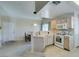 Open-concept kitchen with breakfast bar, white appliances, and plenty of counter space at 2925 Wigwam Pkwy # 1124, Henderson, NV 89074