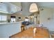 Open floorplan with kitchen and dining area leading to living room with fireplace and built-in shelving at 2925 Wigwam Pkwy # 1124, Henderson, NV 89074