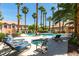 Relaxing community pool area with lounge chairs and palm trees at 2925 Wigwam Pkwy # 1124, Henderson, NV 89074