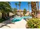 Community pool with palm trees and lounge chairs surrounding at 2925 Wigwam Pkwy # 1124, Henderson, NV 89074