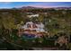 Stunning aerial view of a luxury home with a backyard pool, lush landscaping, and mountain views at 2961 Augusta Dr, Las Vegas, NV 89109
