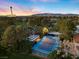 Aerial view of the property showcasing a tennis court, mature trees, and views of the Las Vegas skyline at 2961 Augusta Dr, Las Vegas, NV 89109
