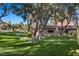 Backyard featuring a lush lawn, mature trees, and desert landscaping, perfect for outdoor activities and relaxation at 2961 Augusta Dr, Las Vegas, NV 89109