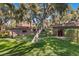 Picturesque backyard with a lush lawn, mature trees, and desert landscaping, offering a tranquil outdoor escape at 2961 Augusta Dr, Las Vegas, NV 89109