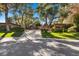 A long driveway leads to this elegant home, complemented by mature trees and manicured landscaping at 2961 Augusta Dr, Las Vegas, NV 89109