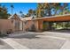 The front entrance with a metal gate and desert landscaping provides a private and inviting approach to the home at 2961 Augusta Dr, Las Vegas, NV 89109