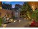Inviting front yard with a serene pond, manicured landscaping, and tiled walkway to the front entryway at 2961 Augusta Dr, Las Vegas, NV 89109