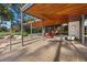 Relaxing covered patio featuring lounge seating and a view of the landscaped yard at 2961 Augusta Dr, Las Vegas, NV 89109