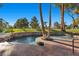 Beautiful pool featuring a unique design with palm trees and surrounding greenery at 2961 Augusta Dr, Las Vegas, NV 89109