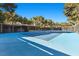 Full tennis court surrounded by mature trees at 2961 Augusta Dr, Las Vegas, NV 89109