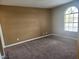 Bedroom showcasing large window, plush carpet, and neutral color scheme at 2986 Juniper Hills Blvd # 202, Las Vegas, NV 89142