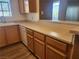 Open kitchen area with wood cabinets, a dishwasher, and light countertops at 2986 Juniper Hills Blvd # 202, Las Vegas, NV 89142