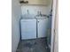 Laundry room equipped with a washer, dryer, and storage shelving at 2986 Juniper Hills Blvd # 202, Las Vegas, NV 89142